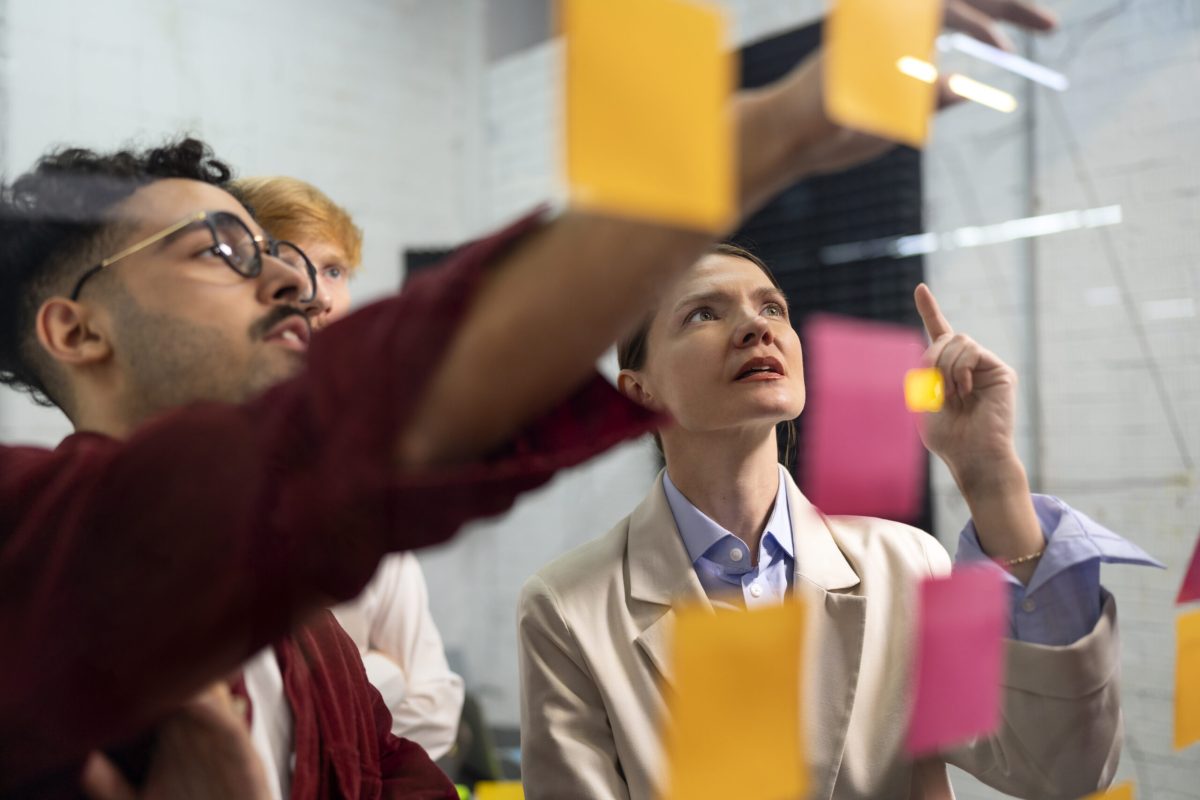 colleagues-thinking-with-post-its-side-view colleagues-thinking-with-post-its-side-view