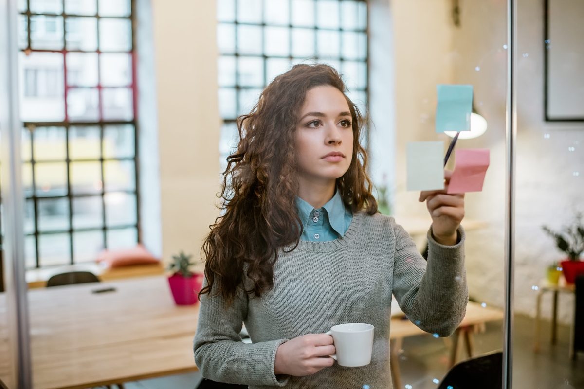 Concept of business woman making plan on sticky notes. Concept of business woman making plan on sticky notes.