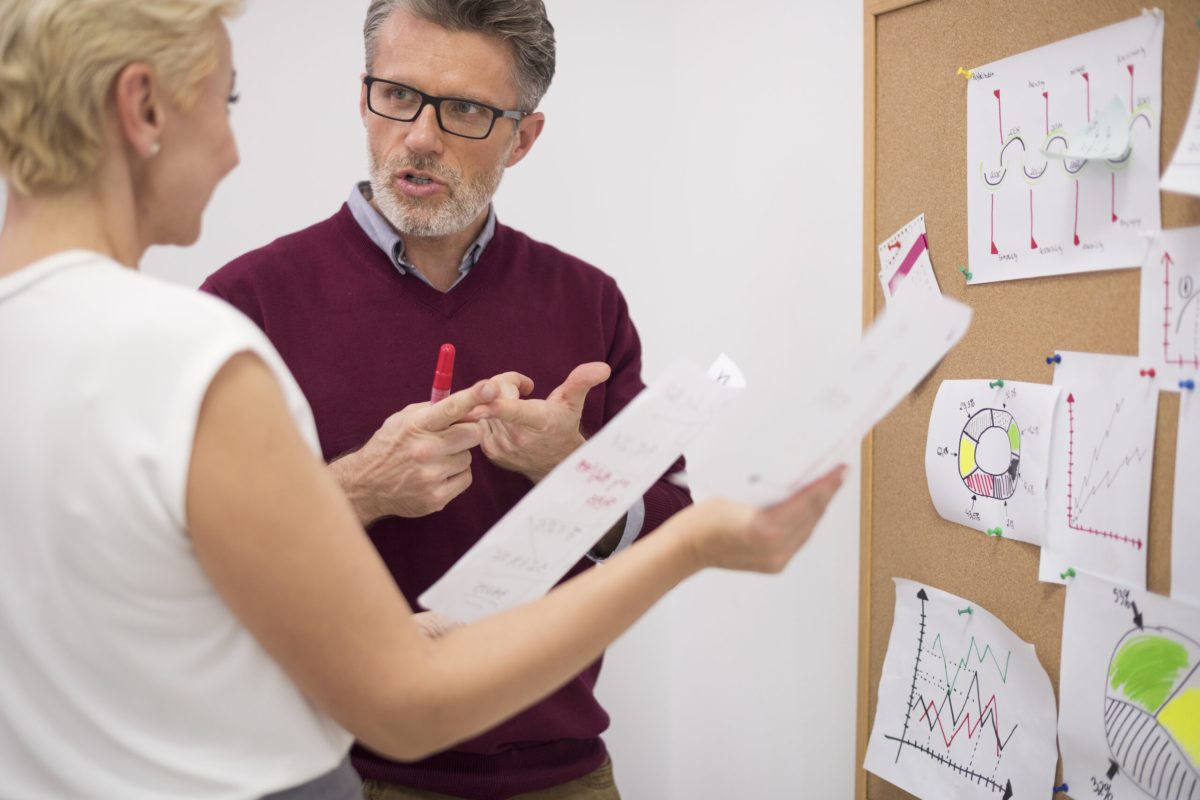 Two business partners alayzing important documents Two business partners alayzing important documents