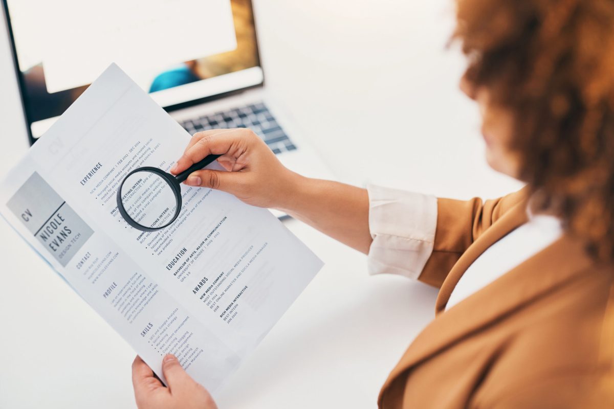 errorcv Hands, cv paper and magnifying glass at hr office with black woman, recruitment or focus at desk. Human resources, documents or zoom for hiring, opportunity or job for future employee with inspection.